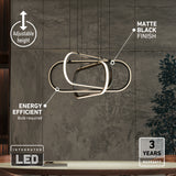 Modern LED pendant light with an abstract geometric design, matte black finish, and adjustable height. Text highlights it as energy efficient, with a 3-year warranty, against a contemporary interior background.