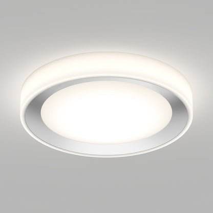 The Artika Cooper LED flush mount light with remote features a modern, round design and a white diffused cover, mounted on a smooth light gray ceiling. It emits a soft, even glow.