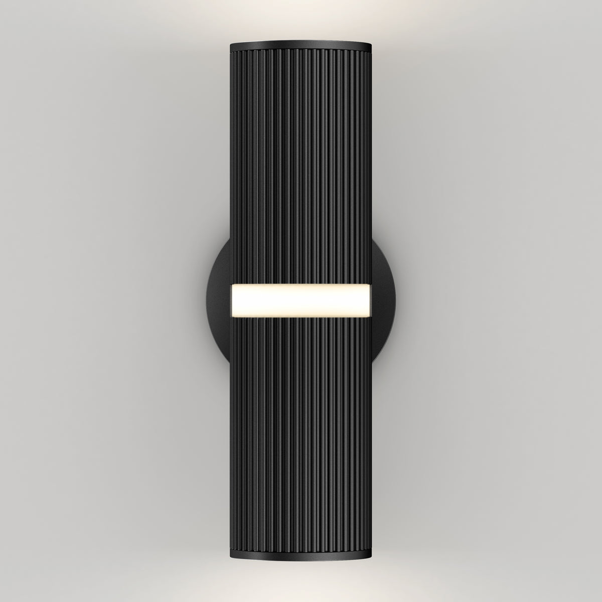 The Artika Groove LED indoor-outdoor wall light features a modern black cylindrical design with vertical ribbing, a circular base, a central horizontal light strip, and glows from both the top and bottom.