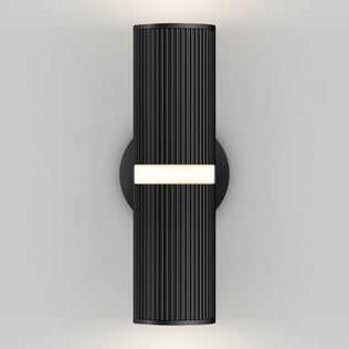 The Artika Groove LED indoor-outdoor wall light features a modern black cylindrical design with vertical ribbing, a circular base, a central horizontal light strip, and glows from both the top and bottom.