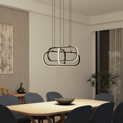 A modern dining room features a wooden table, dark upholstered chairs, a decorative bowl, abstract wall art, and the Artika Lewis modern LED pendant light 3 CCT above the table. A potted plant is by the window.