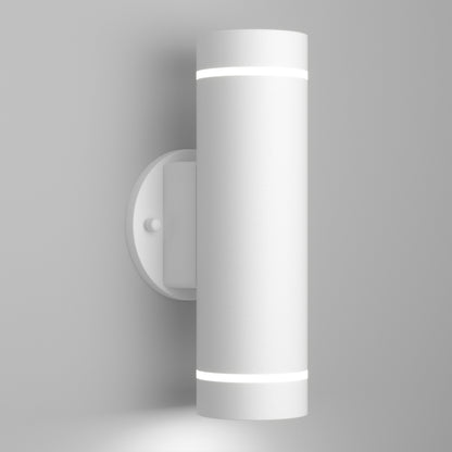 The Artika C7 indoor-outdoor LED wall light 3 CCT is a modern, cylindrical white sconce featuring soft white LED rings at the top and bottom, shown mounted on a plain light gray wall.