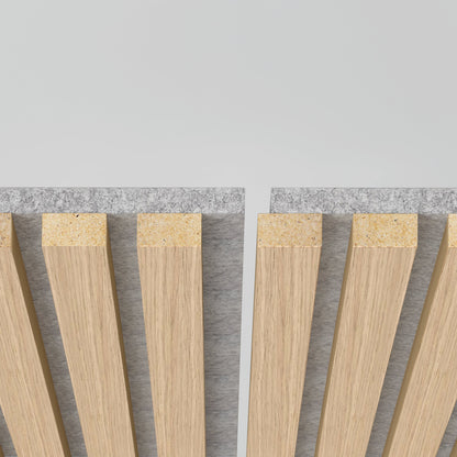 Close-up of Artika-CAN-dev’s Sonolok 15.5 ft sound-absorbing wall panel kit, featuring vertical wooden slats on a gray felt-like backing with a central gap, shown against a plain light background.