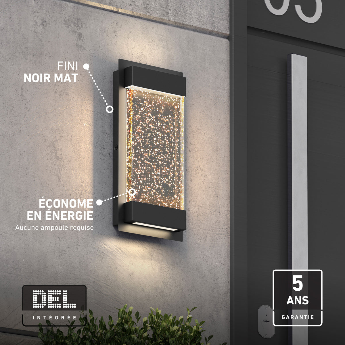 Artika Essence Glow Box LED wall light, black matte, bubble accents, weather-resistant, energy-saving, shown on a gray exterior wall.