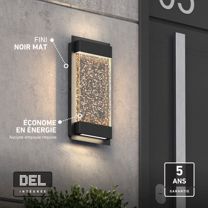 Artika Essence Glow Box LED wall light, black matte, bubble accents, weather-resistant, energy-saving, shown on a gray exterior wall.