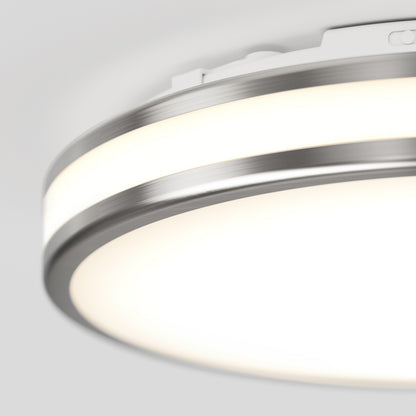 Close-up of the Artika Hemisphere 15 in. LED flush mount light with a sleek metallic edge and bright white surface—features 5 CCT adjustable brightness, perfect for bathroom lighting, set against a plain background.