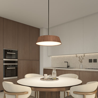 Modern kitchen with minimalist decor featuring wood cabinets, built-in ovens, a round dining table set for four, and neutral tones. The Artika Dunham LED Pendant 5 CCT hangs above the table, which is topped with a tray of glassware.