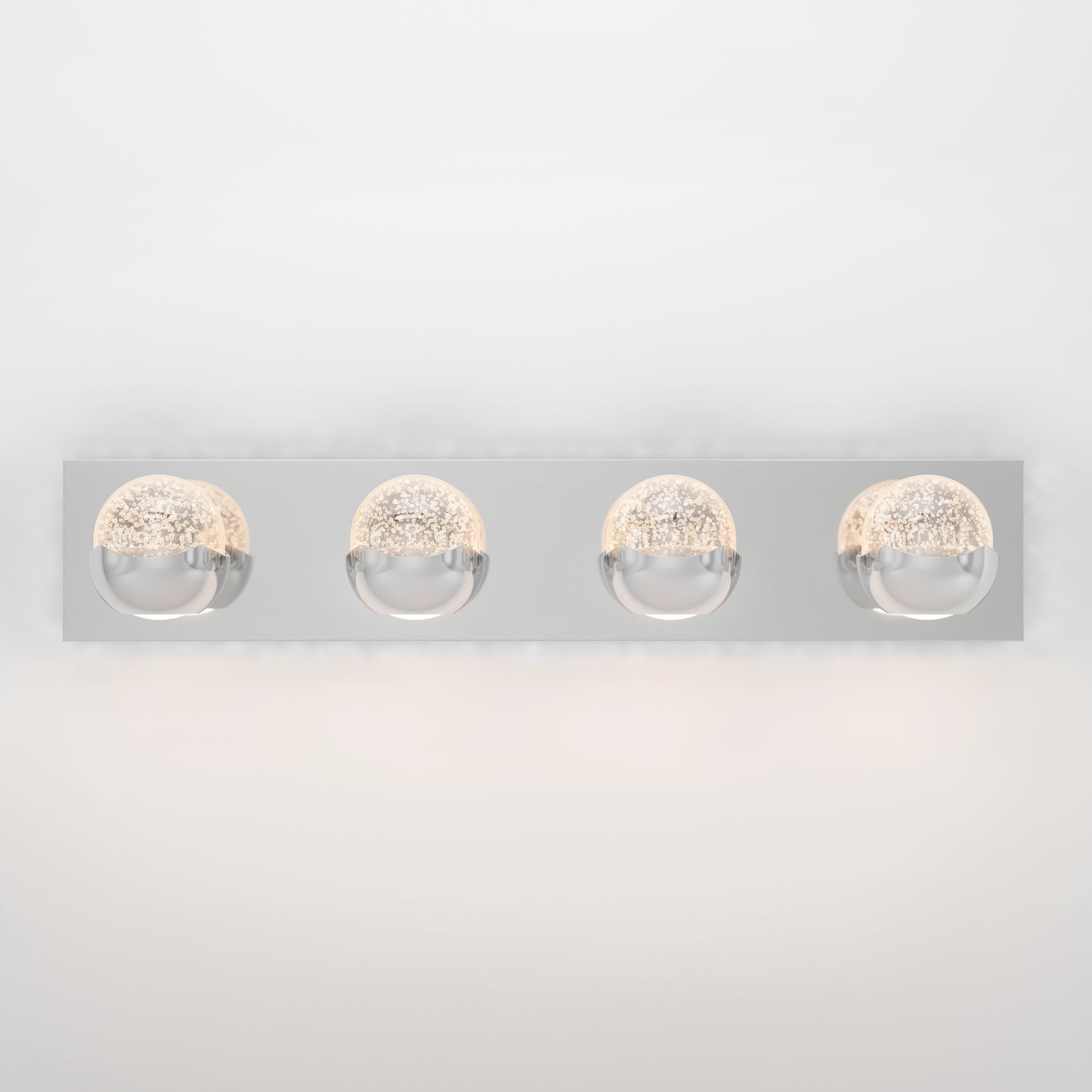 The Artika Oracle LED bathroom vanity light features a rectangular chrome base with four evenly spaced round bulb covers, emitting soft, warm light against a white background.