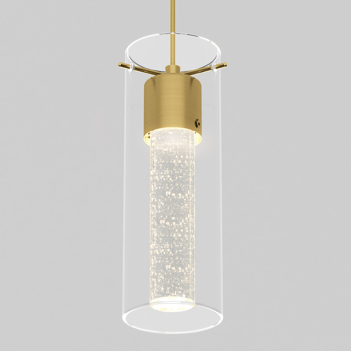 A modern pendant light with a cylindrical glass shade, gold metal accents, and an inner frosted tube filled with small bubbles, suspended against a plain gray background.