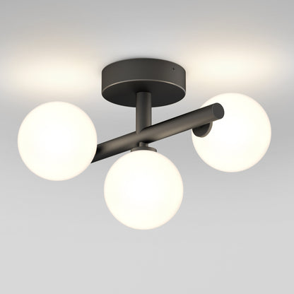 The Artika Bloom LED flush mount is a modern ceiling light featuring a black base and three white glowing spherical bulbs arranged in a triangular pattern.
