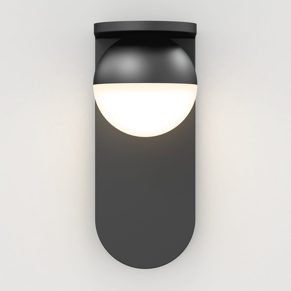 The Artika Bloom indoor-outdoor LED wall light 3 CCT features a modern black design with a rounded base and half-sphere white diffuser, casting a soft, diffused glow on any plain white wall.