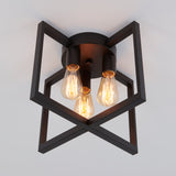 A modern ceiling light fixture with three exposed Edison bulbs, enclosed in a geometric black metal frame, mounted on a white ceiling.