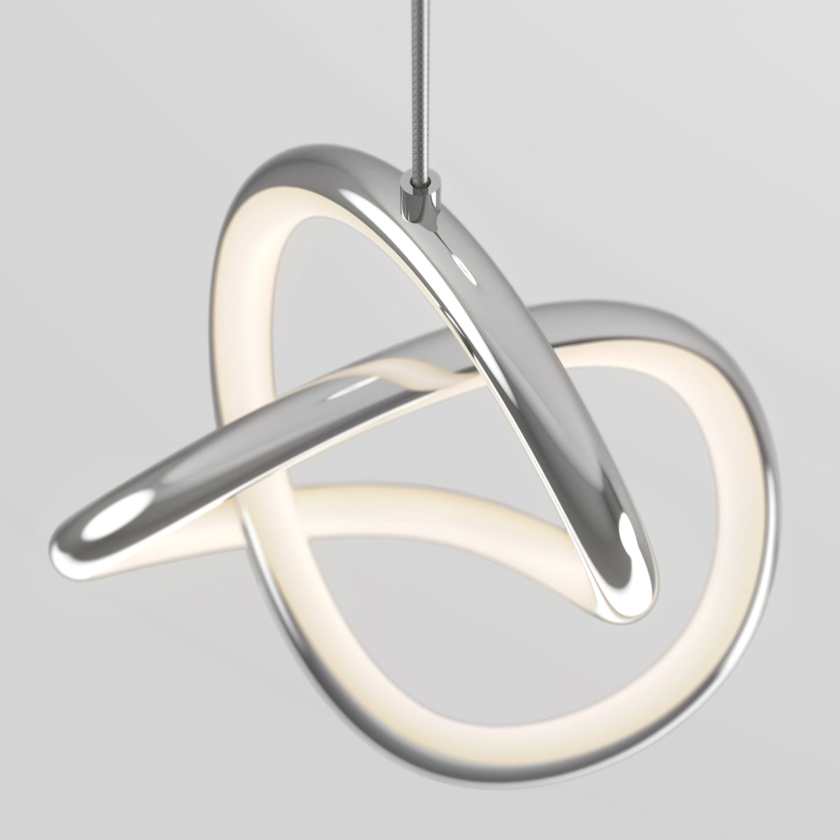 A modern, abstract pendant light fixture with intertwined, chrome-finished loops and integrated LED lighting, suspended from the ceiling by a single cable against a light gray background.