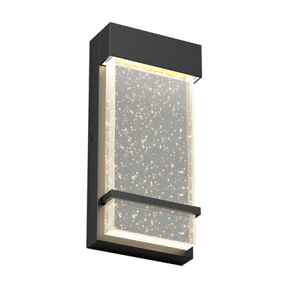 The Skyler indoor-outdoor LED wall light by Artika features a modern rectangular design with a black frame and a frosted glass panel adorned with bubble-like patterns, illuminated from within by energy-efficient LEDs.