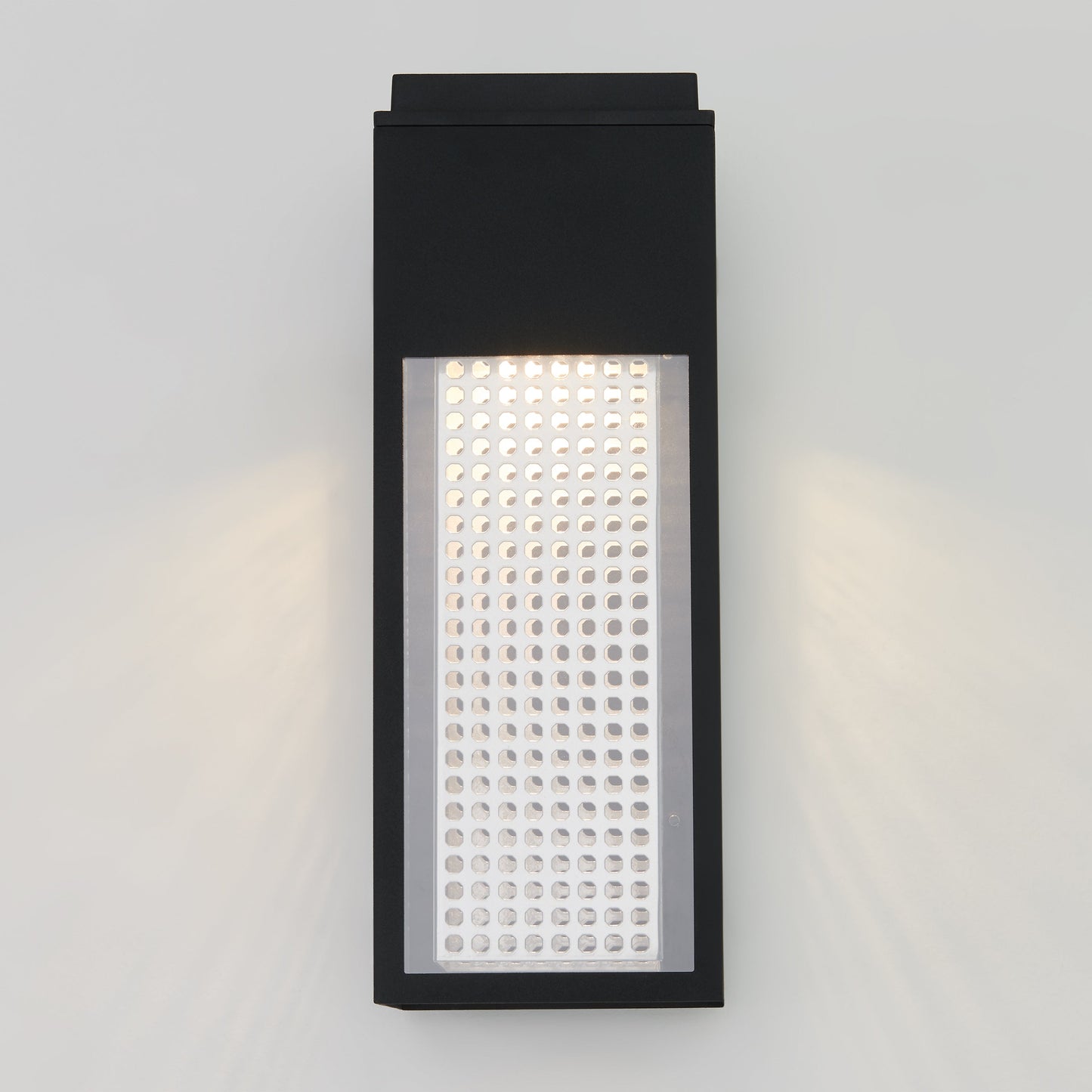 The Meteor LED indoor/outdoor wall light by Artika-CAN-dev features a modern rectangular black frame with a perforated white panel, casting light through small circular holes and gently illuminating your wall.