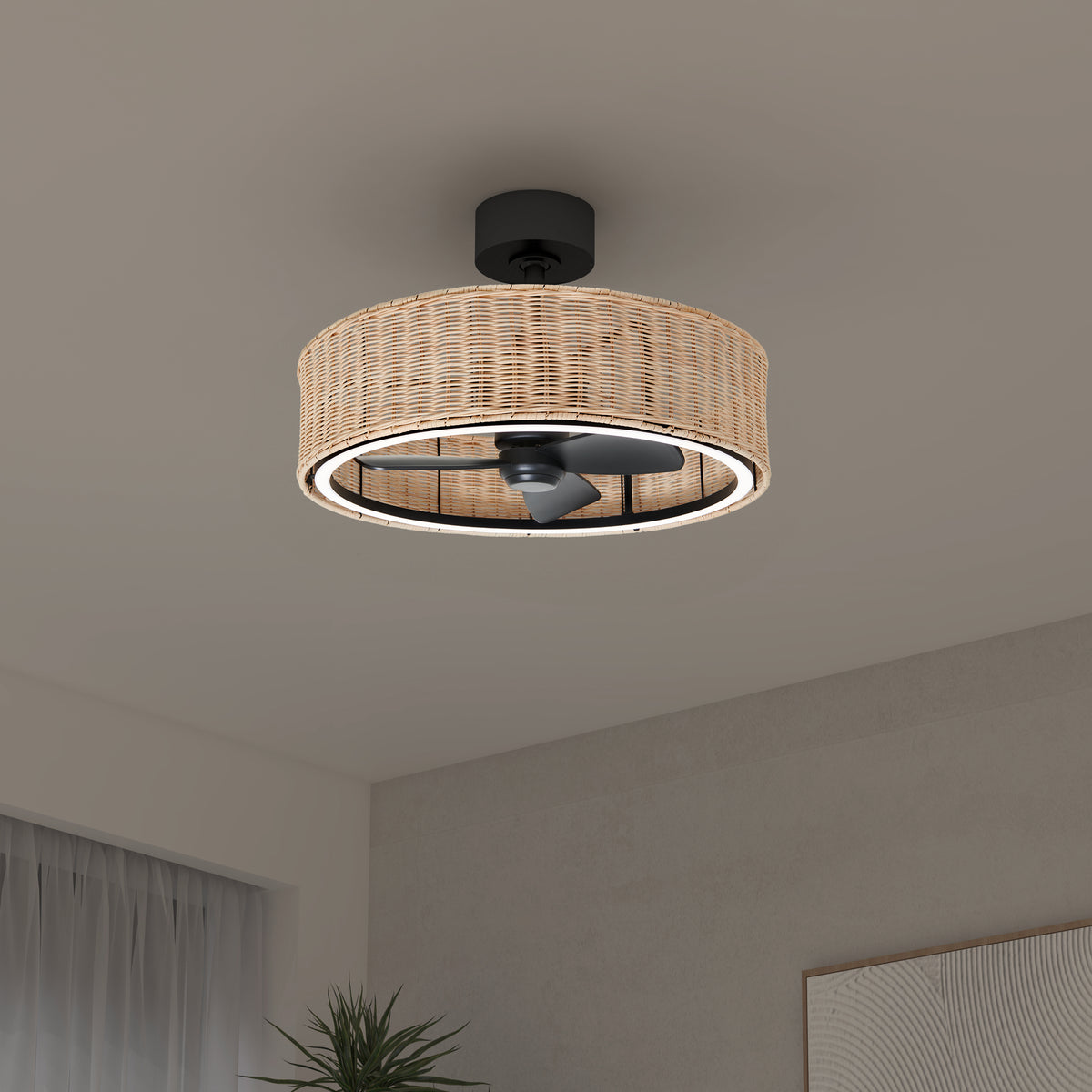 A modern ceiling fan with a circular wicker-style light fixture is mounted on a white ceiling in a minimal, neutral-toned room with a plant and sheer curtains visible in the background.