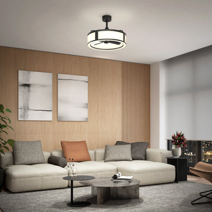 Modern living room with a large beige sectional sofa, assorted cushions, abstract art on a wood-paneled wall, round coffee tables, and the Artika Huxley 23 in. LED modern ceiling fan (3 speeds), plus a window with city night views.