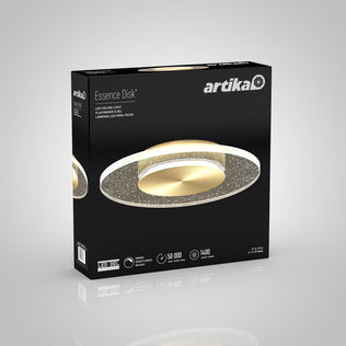 A black and gold Artika box for the Essence Disk LED flush mount shows the fixture image, product name, and icons for 50,000-hour lifespan, 1400 lumens brightness, and LED technology.