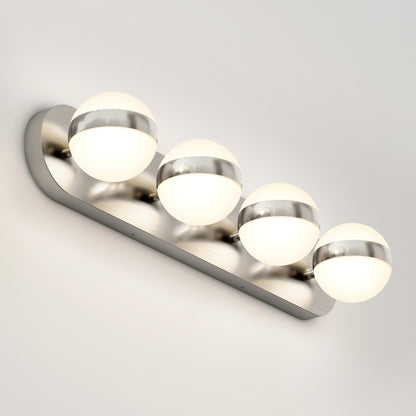 The Artika Baldric LED modern bathroom vanity light 3 CCT features four round frosted glass globes with metallic bands on a brushed metal base, creating a sleek look for any white wall.