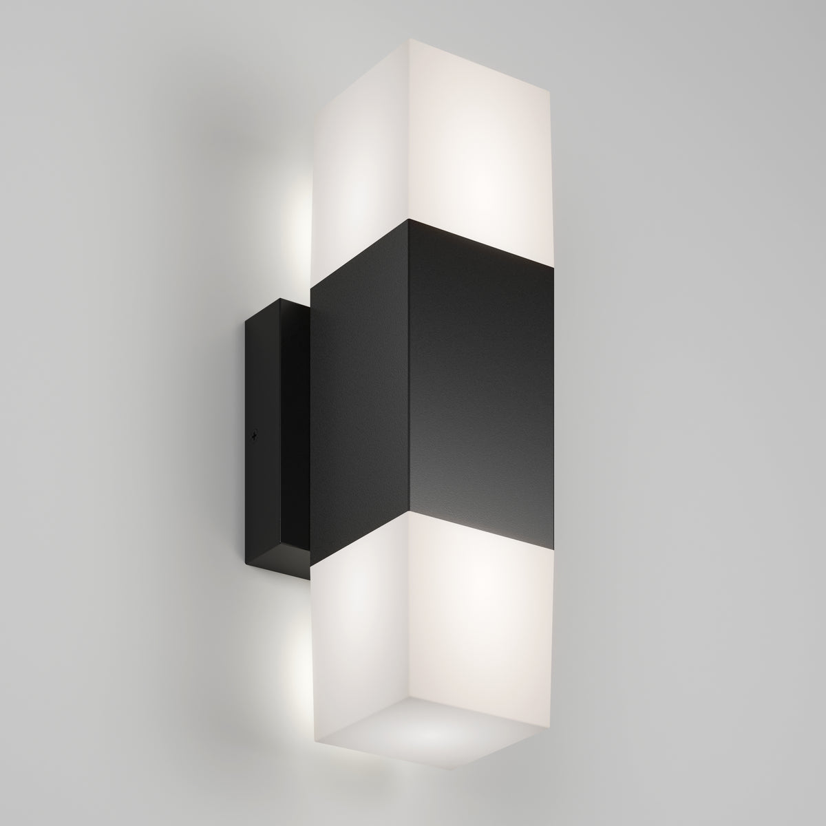The Artika Lennox indoor-outdoor LED wall light 3 CCT features a rectangular black center with frosted white diffusers on top and bottom, mounted on a light gray wall.