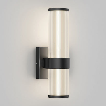 The Artika Mirado modern LED wall sconce 5 CCT features a black rectangular mount with two vertically aligned ribbed frosted glass tubes, emitting soft, even light to enhance any space.