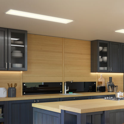Modern kitchen with dark cabinets, glass doors displaying dishes, light wood countertops and backsplash, a kitchen island, and Artika Sunray ultra thin LED light panel 3 CCT as under-cabinet lighting. Kitchen appliances and utensils are visible on the counters.
