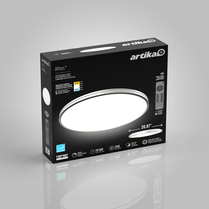 The Artika Athos 21 in. LED flush mount light packaging features a sleek black box, a bright round white light, remote control image, dimensions (20.87”), and icons for adjustable brightness, long lifespan, and color temperature settings.