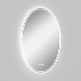 A round, wall-mounted mirror with a built-in LED light glowing around its edge, set against a plain light gray background. Three touch control buttons are visible at the bottom of the mirror.