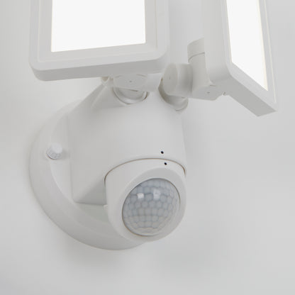 A close-up of the Artika Sentinel outdoor Flat Panel Security light, featuring two rectangular LED panels and a round motion sensor, mounted on a wall.