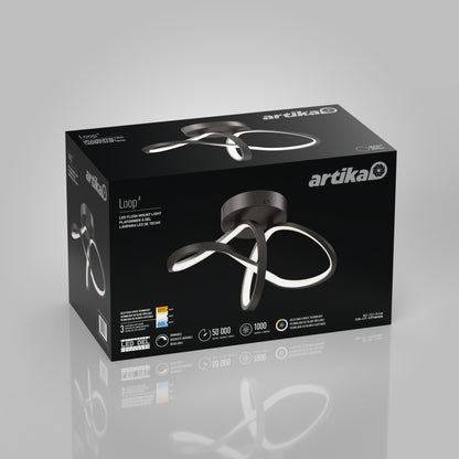 A black box of the Artika Loop modern LED flush mount light 3 CCT, displaying an image of the curved fixture on the front, with product features and branding in white and silver text.