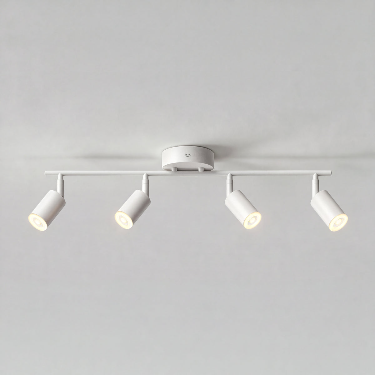 Artika Asher 32 in. 4-Light LED Track Light 3CCT with adjustable spotlights, illuminated against a plain gray backdrop.