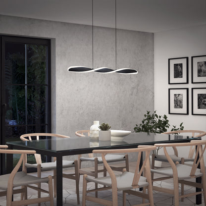 A modern dining room features a glass table, six light wooden chairs, a plant, wall art, and the Artika Finley Linear LED pendant light (3 CCT) in sleek black. A large window reveals lush greenery outside.