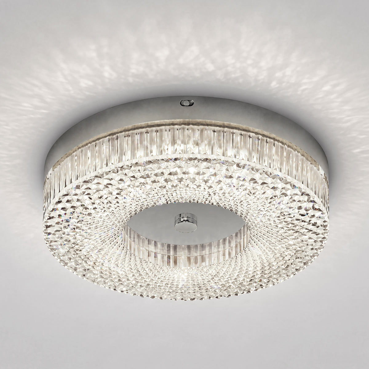 Artika FM Lysara 15 in. LED Fashion Flush Mount Ceiling Light 5 CCT with a faceted crystal ring and a polished metal center.