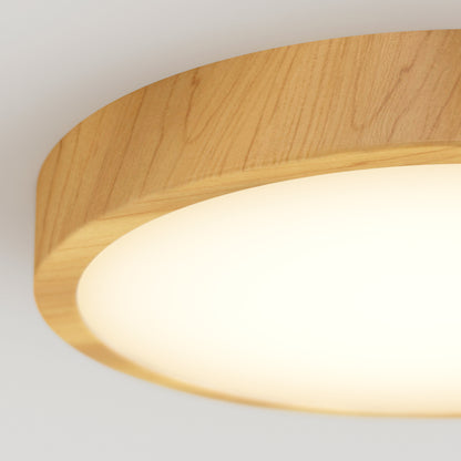 A close-up of the Artika Dryad 15 in. LED Modern flush mount light featuring a wooden frame and a circular glowing white diffuser, mounted on a plain white ceiling.