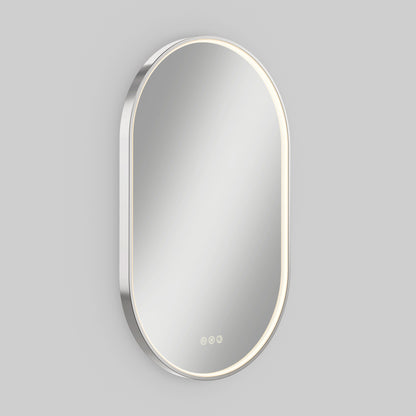 The Artika Royce LED mirror 3 CCT with defogger is a modern oval wall mirror featuring built-in edge LED lighting and three touch controls at the bottom, displayed against a plain light gray background.