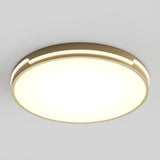 A modern, round ceiling light fixture with a warm, glowing white center and a beige outer rim, mounted against a plain light gray ceiling.
