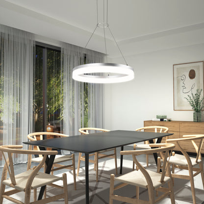 A modern dining room featuring a black rectangular table, six wooden chairs, sheer curtains, minimalist decor with framed abstract art and greenery, and the Artika Optical LED pendant light 3 CCT as a stylish centerpiece.