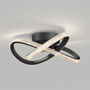 The Artika Morgan modern LED flush mount light 5 CCT features two intertwined black metal loops with LED crystals, mounted on a circular black base, perfect for adding a stylish touch to any ceiling.