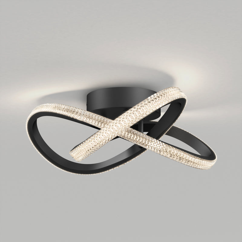 The Artika Morgan modern LED flush mount light 5 CCT features two intertwined black metal loops with LED crystals, mounted on a circular black base, perfect for adding a stylish touch to any ceiling.