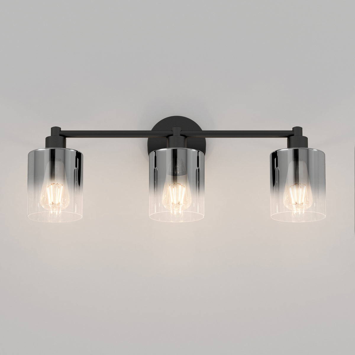 The Artika Haze modern 3-light bathroom vanity light features three exposed bulbs in cylindrical clear glass shades, mounted on a sleek horizontal black metal bar.