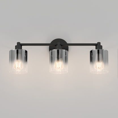 The Artika Haze modern 3-light bathroom vanity light features three exposed bulbs in cylindrical clear glass shades, mounted on a sleek horizontal black metal bar.