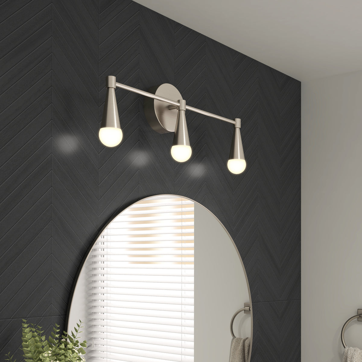 Artika Wayden LED mid-century vanity light (3 CCT) above a round mirror on a dark herringbone wall.