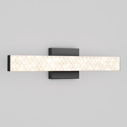 The Artika Adeline modern LED bathroom vanity light 3 CCT features a rectangular black base and a long, textured crystalline glass bar, wall-mounted and set against a plain light gray background.