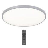 A round, flat LED ceiling light with a frosted white cover and silver rim, shown above a black remote control with multiple buttons.