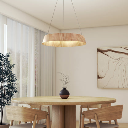 A minimalist dining room features a round wooden table, four matching chairs, a black vase with twigs, large abstract wall art, a potted plant, and the Artika Tallis LED pendant light 5 CCT hanging above the table.
