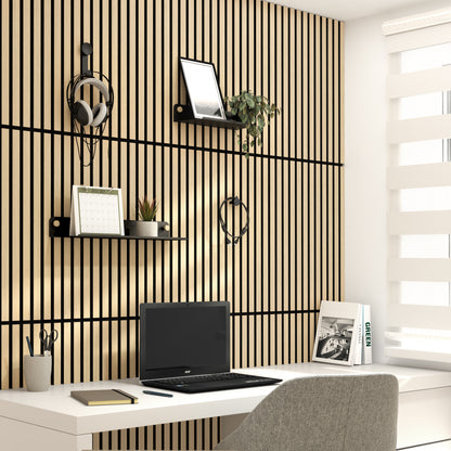 Minimalist home office with a white desk, gray chair, and natural light from a window with white blinds. The wall features Artika’s Sonokit shelves and hooks for Sonolok and Sonofold panels, adding stylish organization to the space.