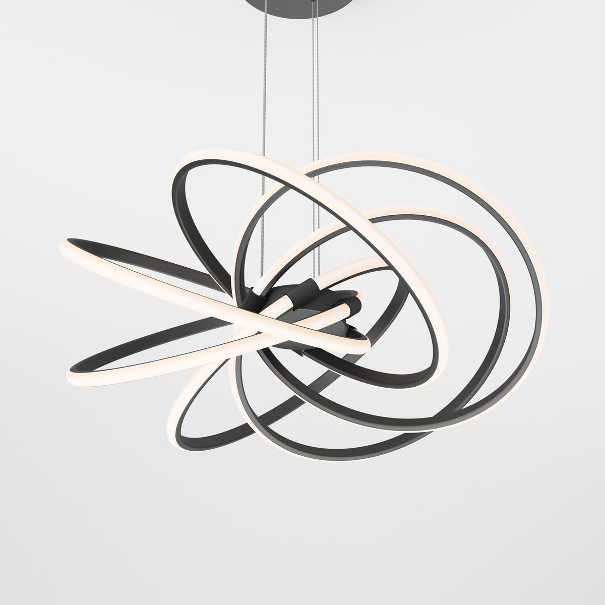 A modern ceiling light fixture featuring several intertwined black and white LED rings, suspended by thin cables against a plain white background.