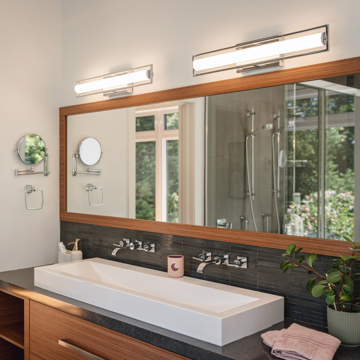 Modern bathroom with a double faucet sink and Artika Rialto 27-in LED 3-CCT Vanity Light Bar installed above a large mirror.