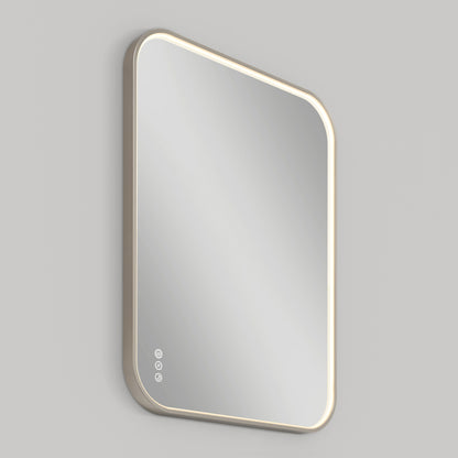 The Artika Royce Dimmable LED Mirror, 3 CCT, features a rectangular design with rounded edges, a beige frame, and three touch buttons on the bottom left. Mounted on a light gray wall, it supports both horizontal and vertical installation.