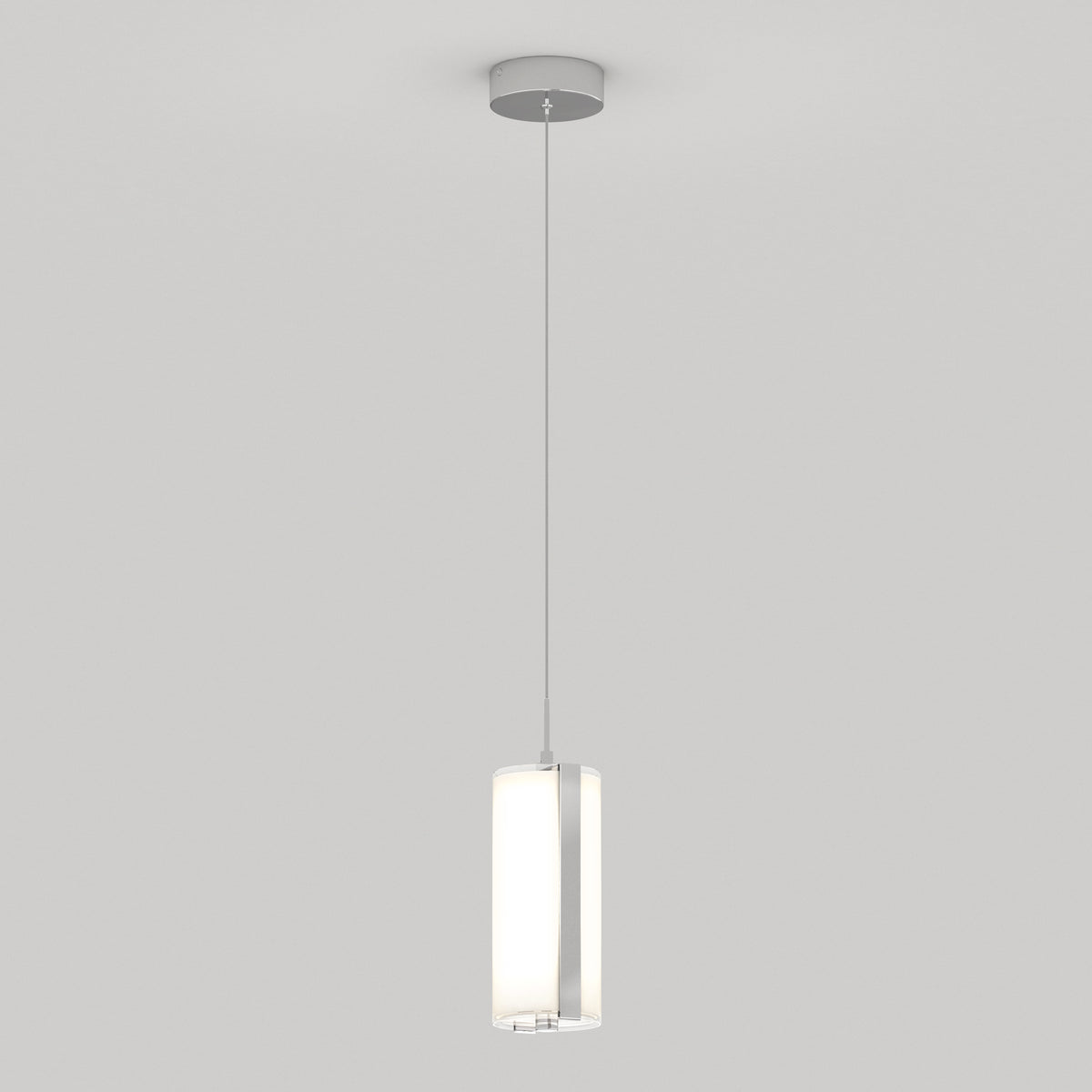 A modern pendant light with a cylindrical frosted glass shade hangs from a thin cord attached to a round ceiling mount against a plain white background.